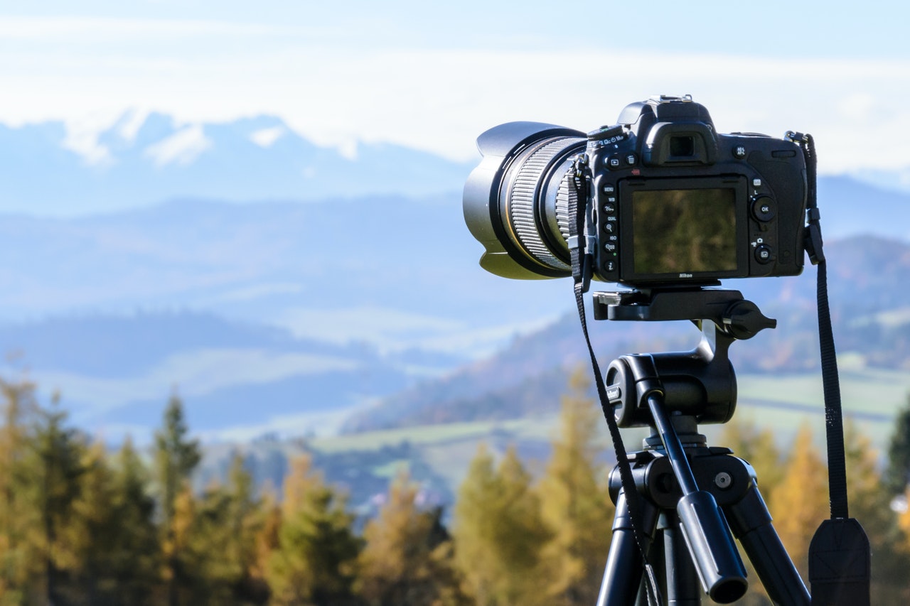 black-dslr-camera-mounted-on-black-tripod-212372